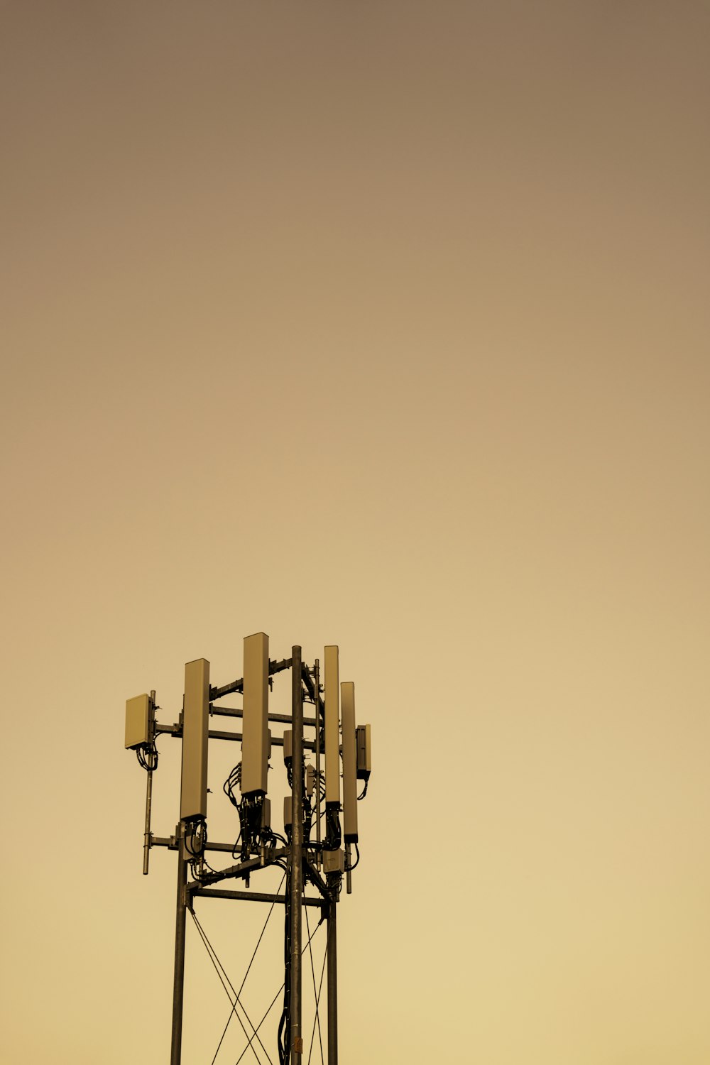 a tall tower with a bunch of cell phones on top of it