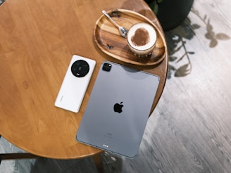 A phone stand supporting a device during a video call, placed next to a coffee cup.