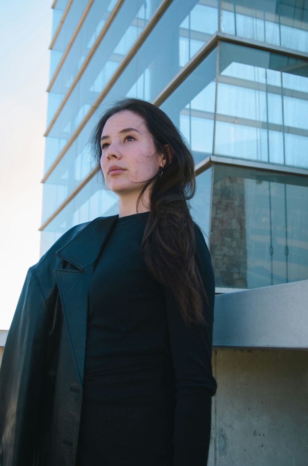 a woman standing in front of a tall building