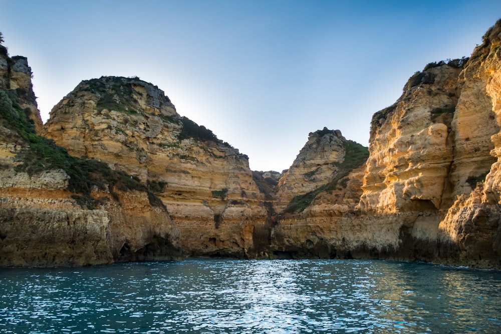 a body of water surrounded by rocky cliffs