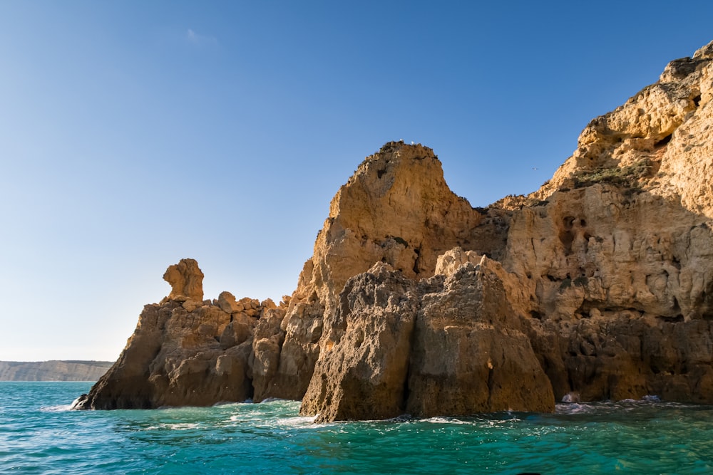 a rock formation in the middle of a body of water