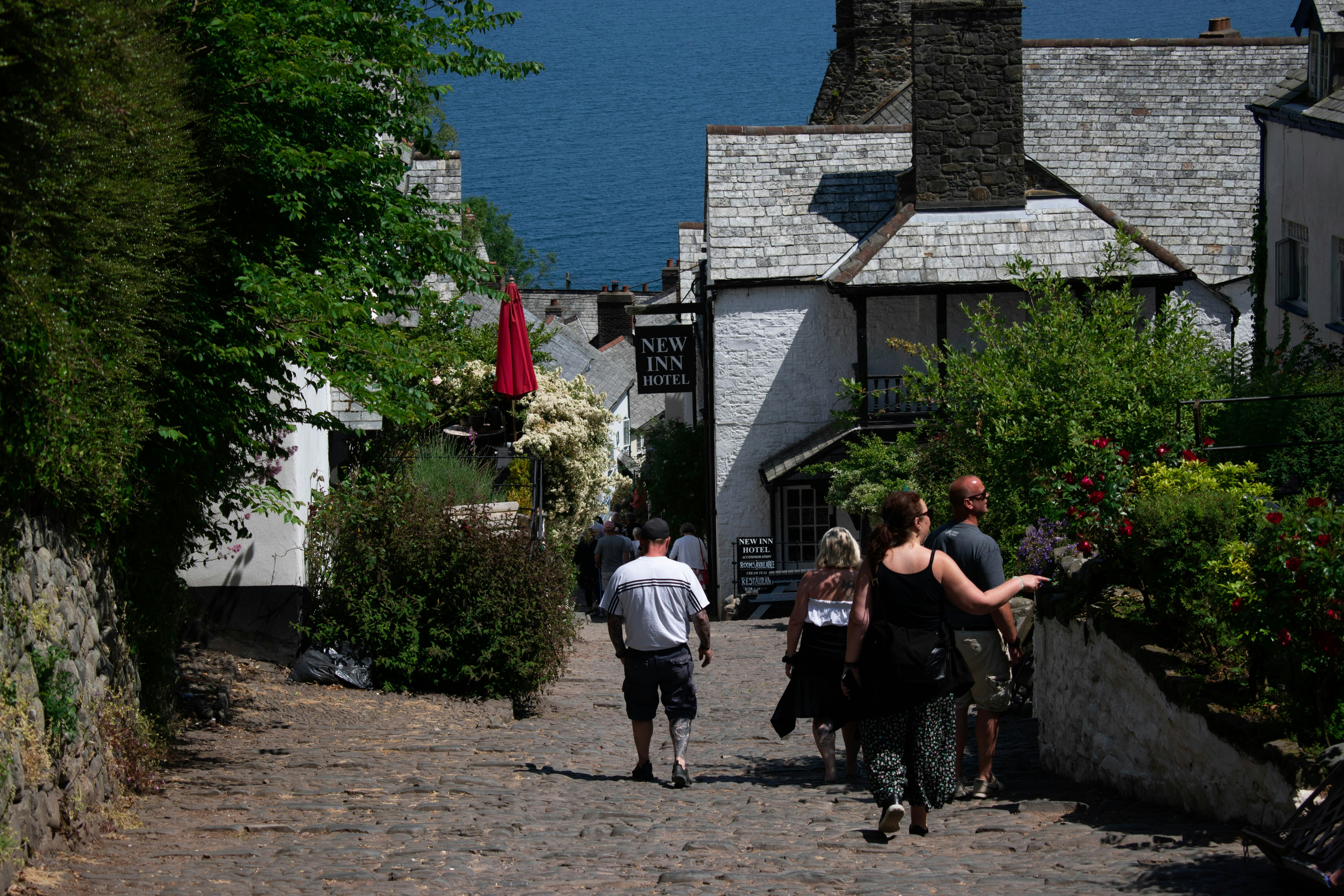 a group of people walking down a cobblestone road