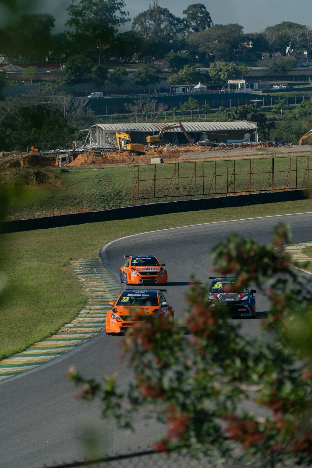 a couple of cars driving down a race track