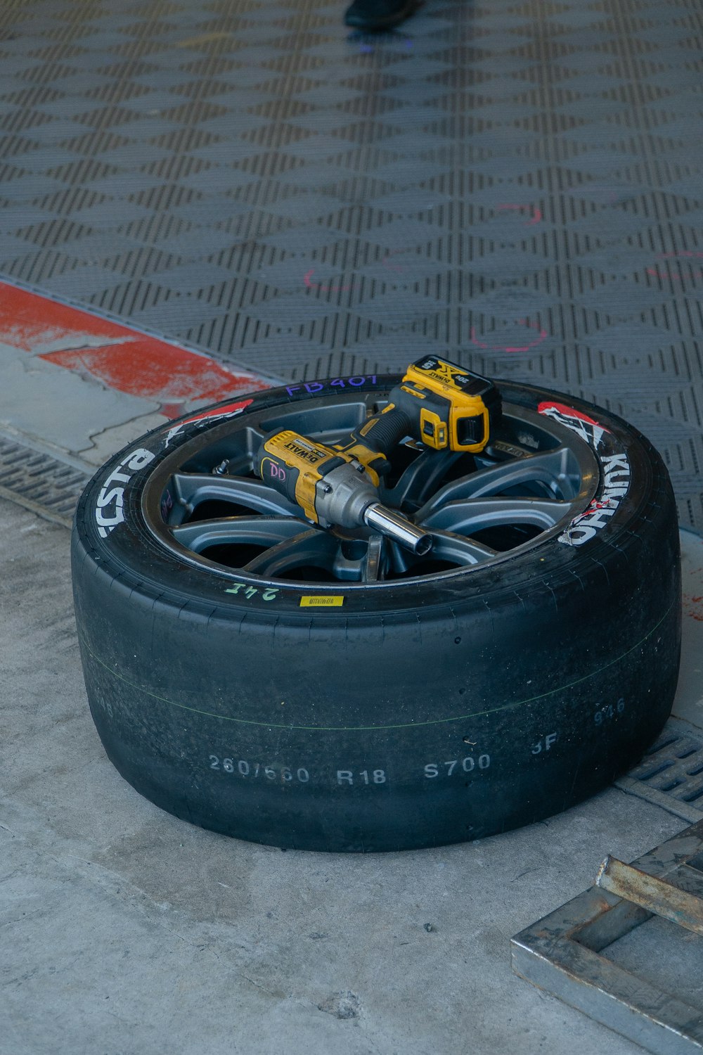 ein Reifen, der neben einem Schacht auf dem Boden liegt