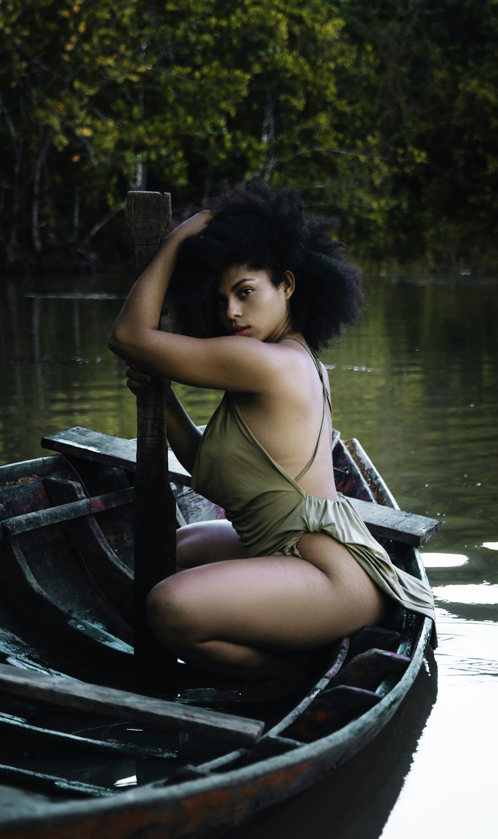 a woman in a bathing suit sitting in a boat