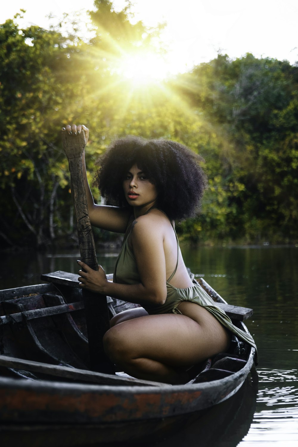 a woman in a bikini is sitting in a boat