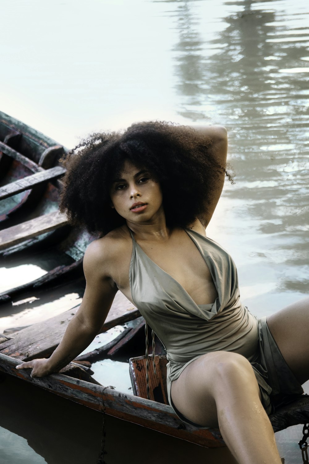 a woman in a bathing suit sitting on a boat