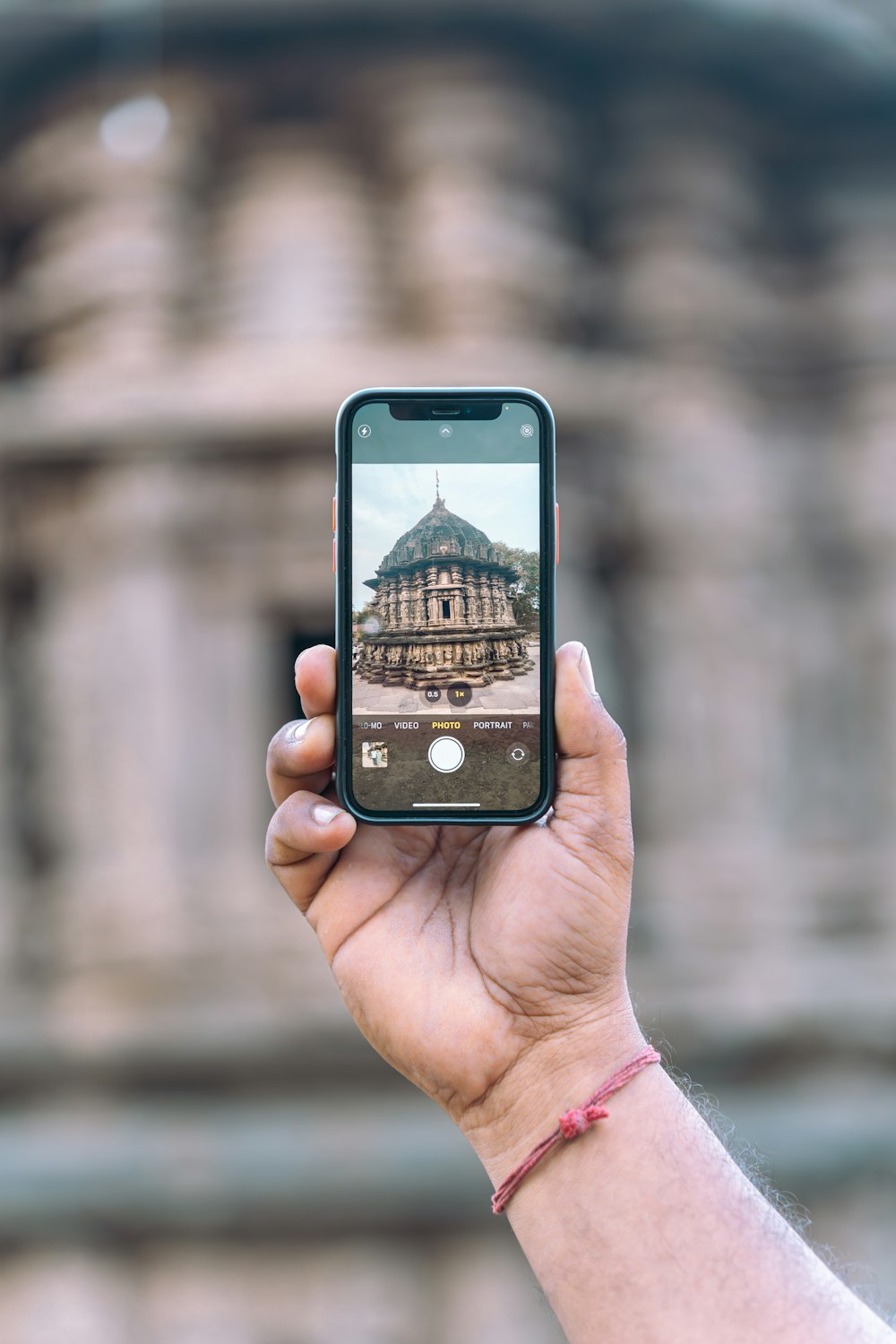 a person taking a picture of a building with a cell phone