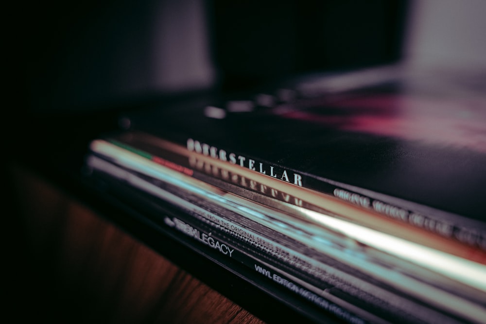 a stack of magazines sitting on top of a wooden table