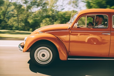 Image of a happy family driving their car, protected by GEICO insurance.