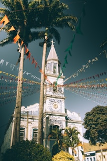 Sunset view of the church building decorated with colorful flags representing Latin American countries.