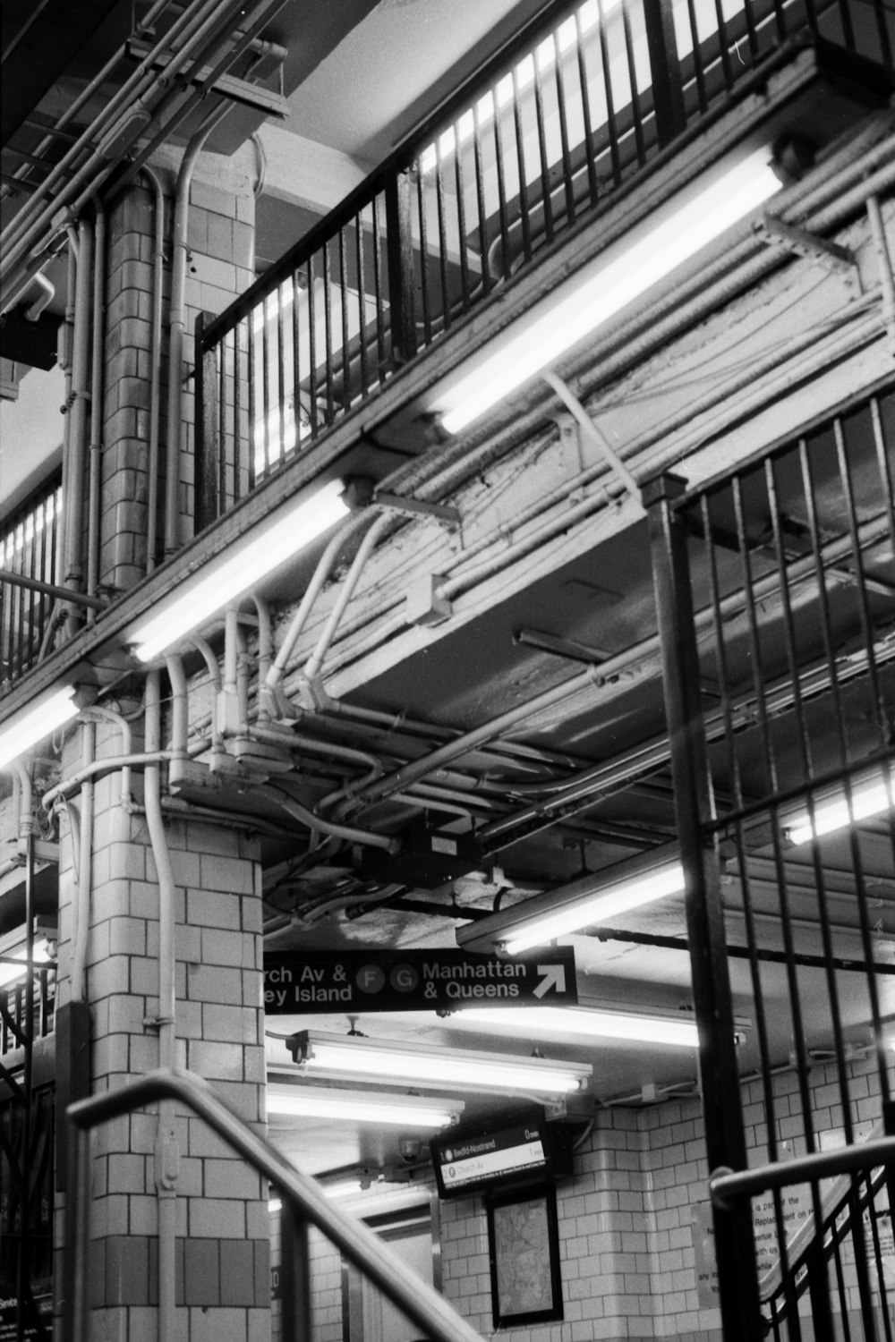 a black and white photo of a subway station