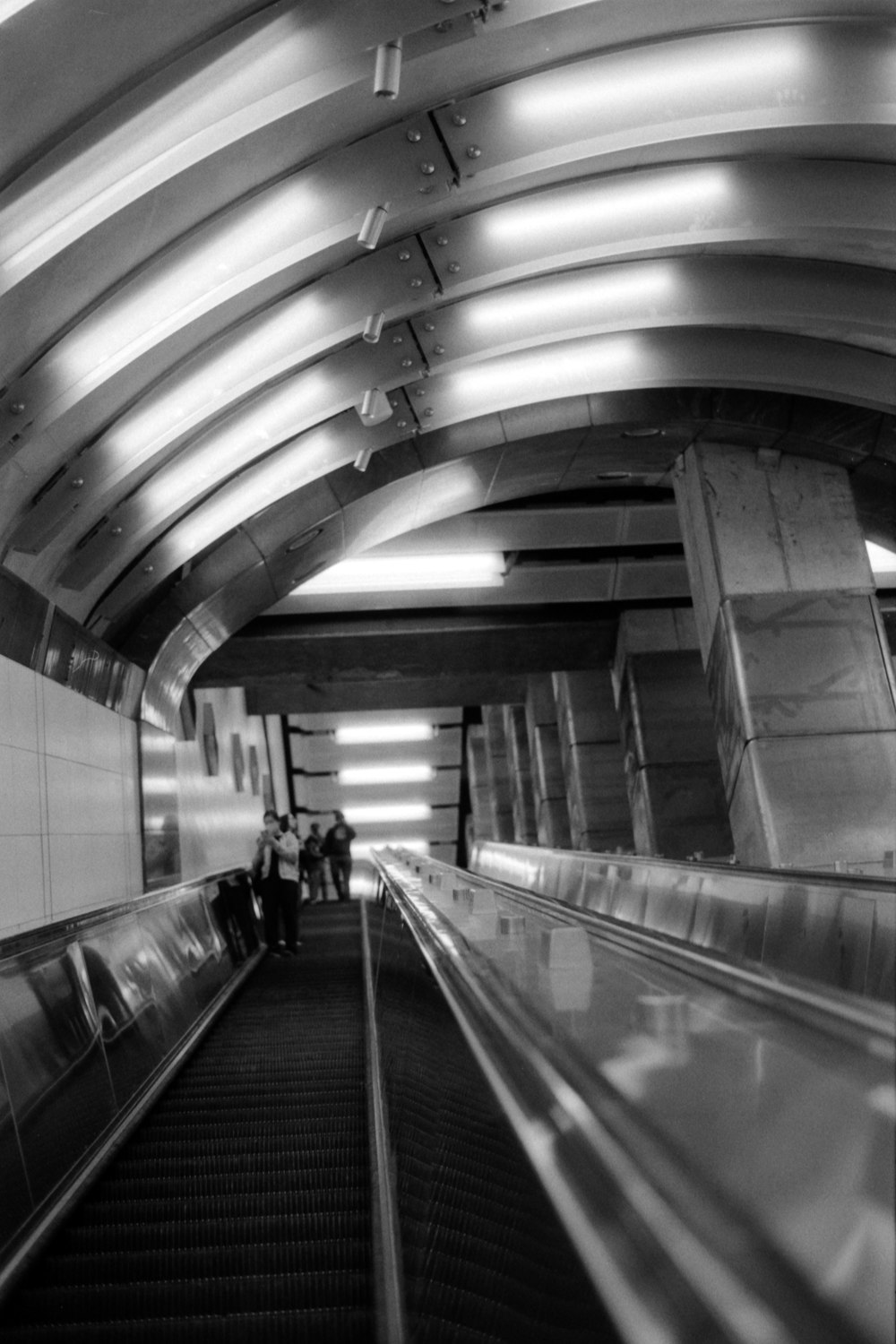 a black and white photo of an escalator