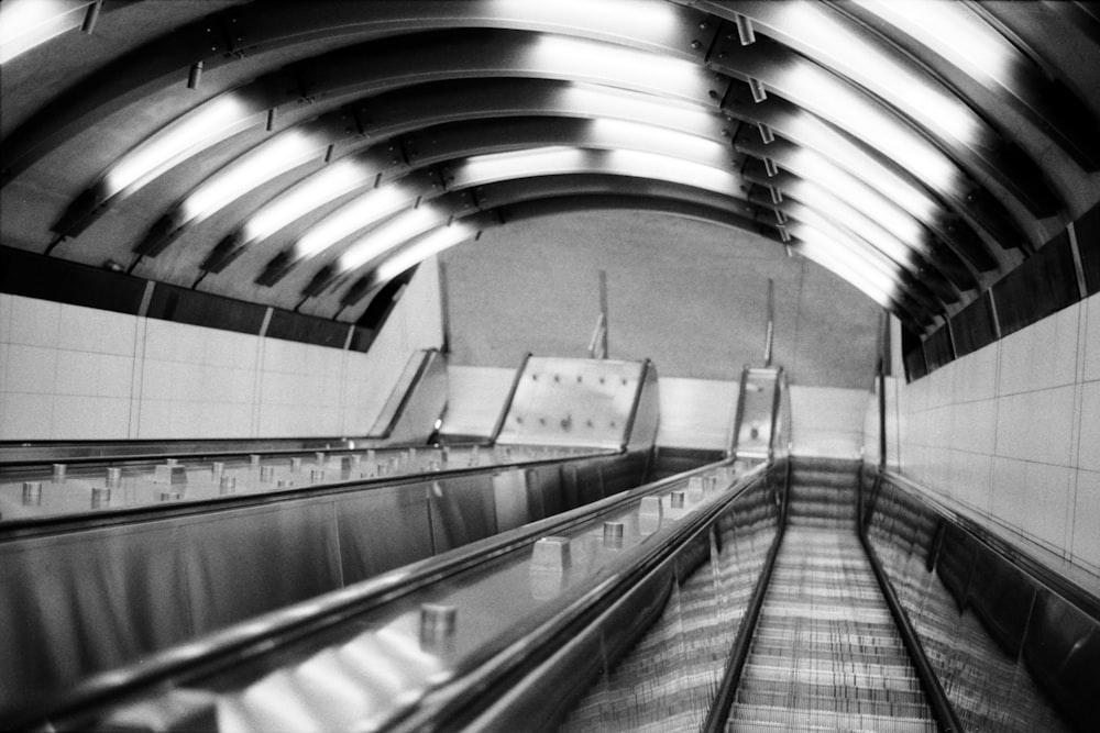 a black and white photo of an escalator