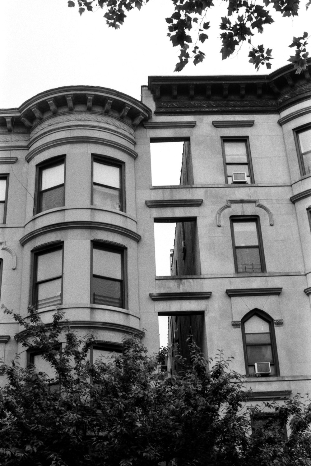 a black and white photo of a row of buildings
