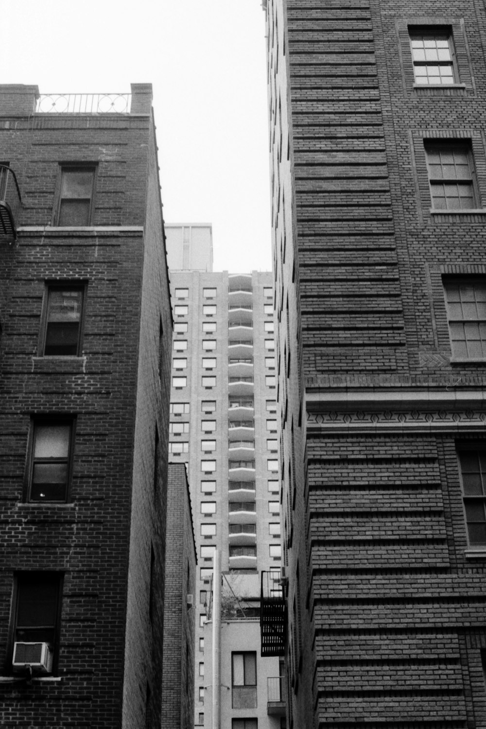 a black and white photo of tall buildings