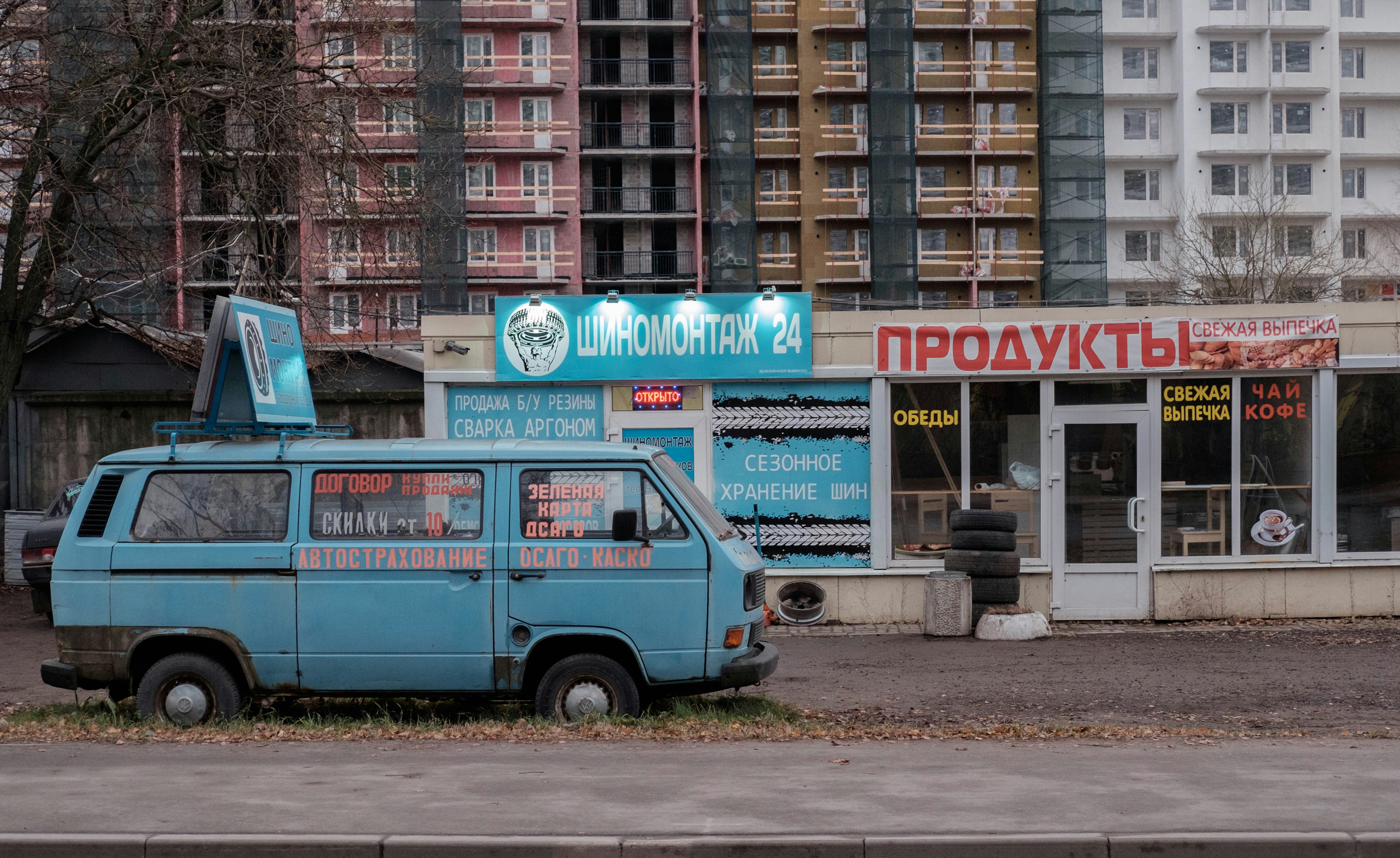 a blue van parked in front of a building