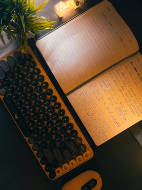 A cozy workspace with a warm lamp, keyboard, and notebook inviting communication.