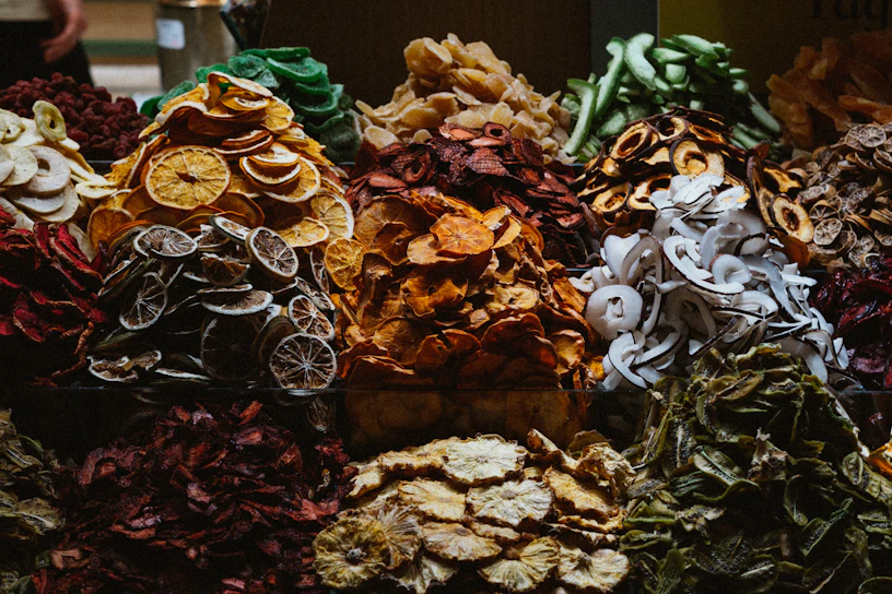 Close-up of a vibrant assortment of premium dry fruits arranged in a rustic wooden tray.