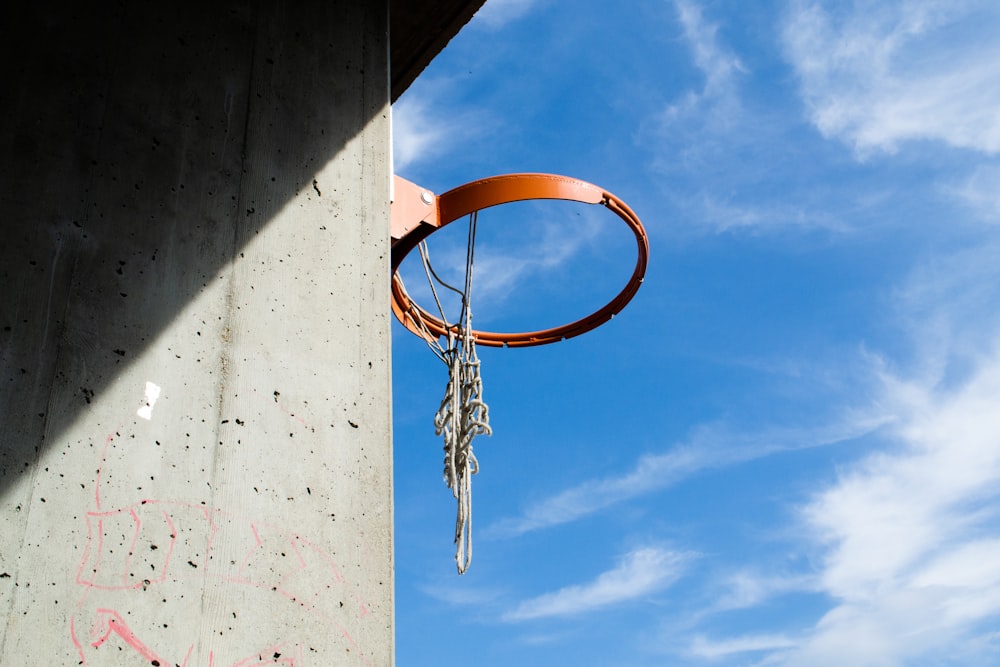 a basketball hoop hanging from the side of a building