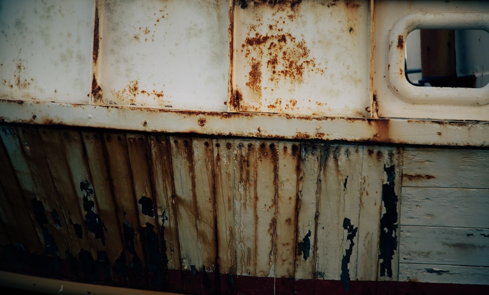 an old rusted metal wall with a window