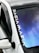 A close-up view of a car windshield featuring a reflective surface with a gradient of blue and purple tones. The car is white with a side mirror and a black roof. The words 'DACIA MAFIA' appear in bold white letters along the edge of the windshield.