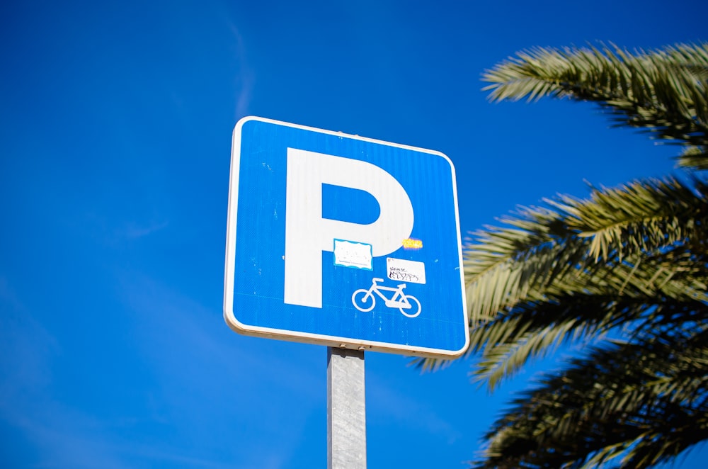 a blue parking sign with a bicycle on it