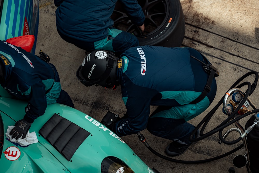 two mechanics working on a racing car