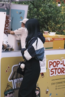 Nathan showcasing merchandise at a pop-up shop event.