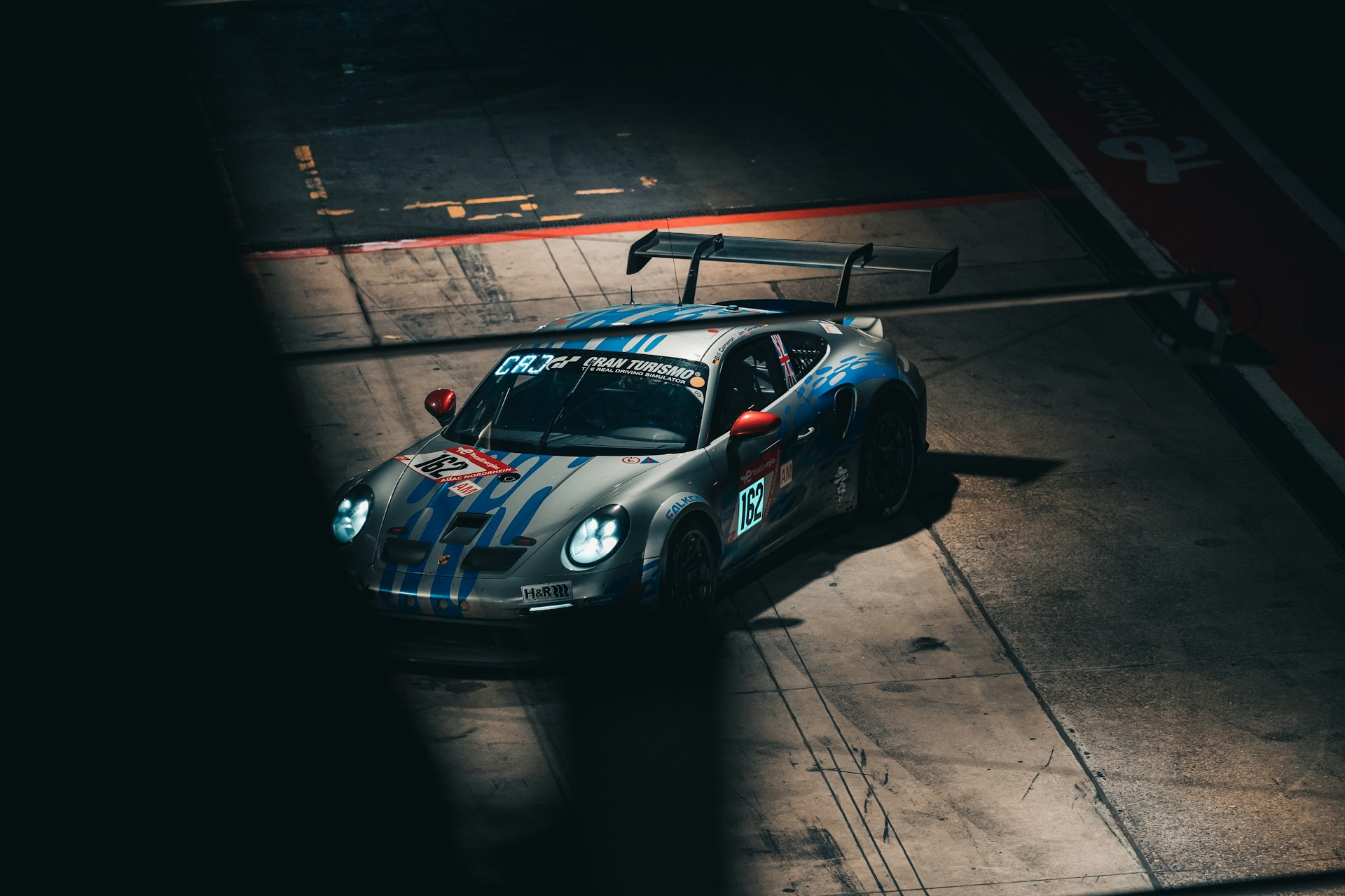 a car driving down a race track at night