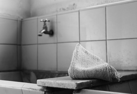 a towel sitting on top of a bath tub next to a faucet