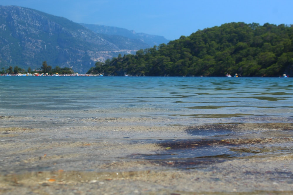 a body of water with a mountain in the background