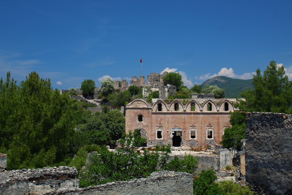 the ruins of an old building with a mountain in the background