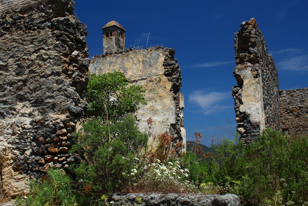 a stone wall with a clock tower on top of it