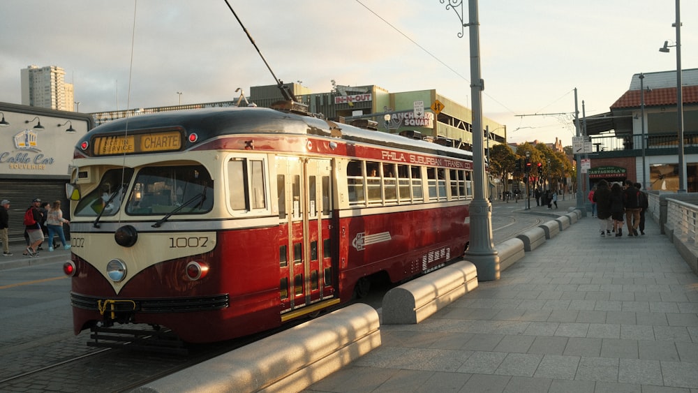 a red and white train traveling down train tracks