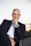 Portrait of the Chief Advisor in a professional setting, exuding wisdom and approachability.