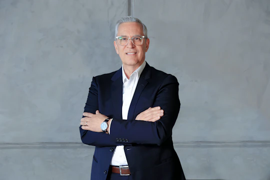 a man in a suit standing with his arms crossed