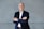 a man in a suit standing with his arms crossed