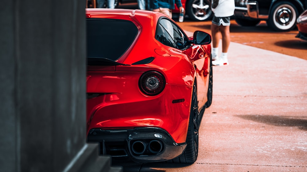 a red sports car parked in a parking lot