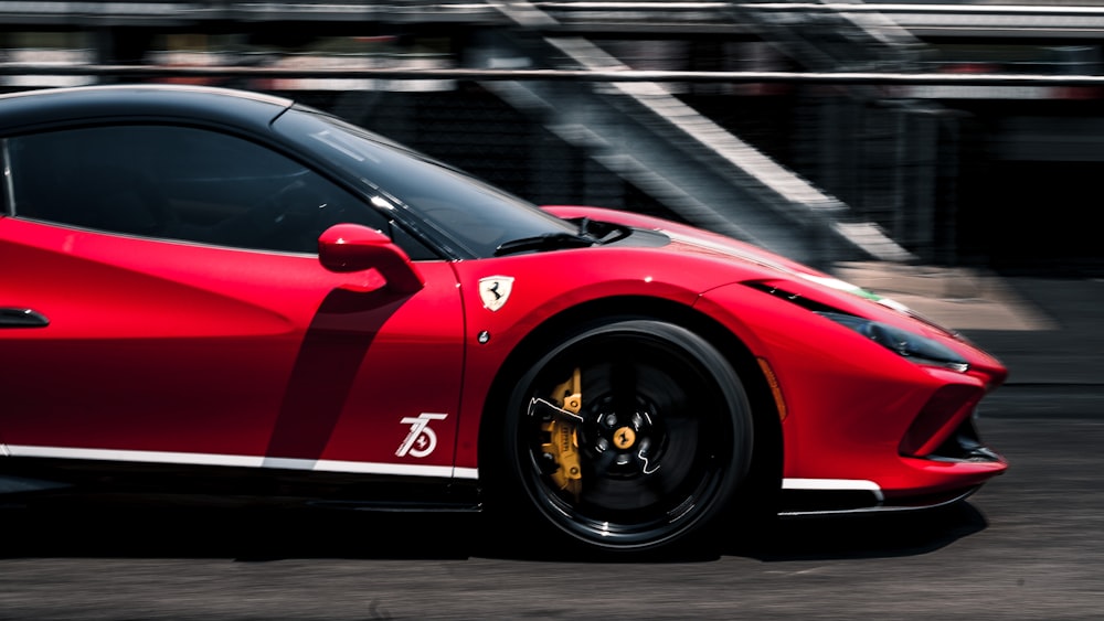 a red sports car driving down a street