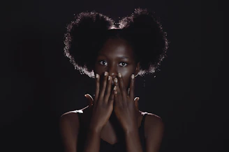 a woman covering her face with her hands