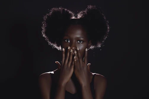 a woman covering her face with her hands
