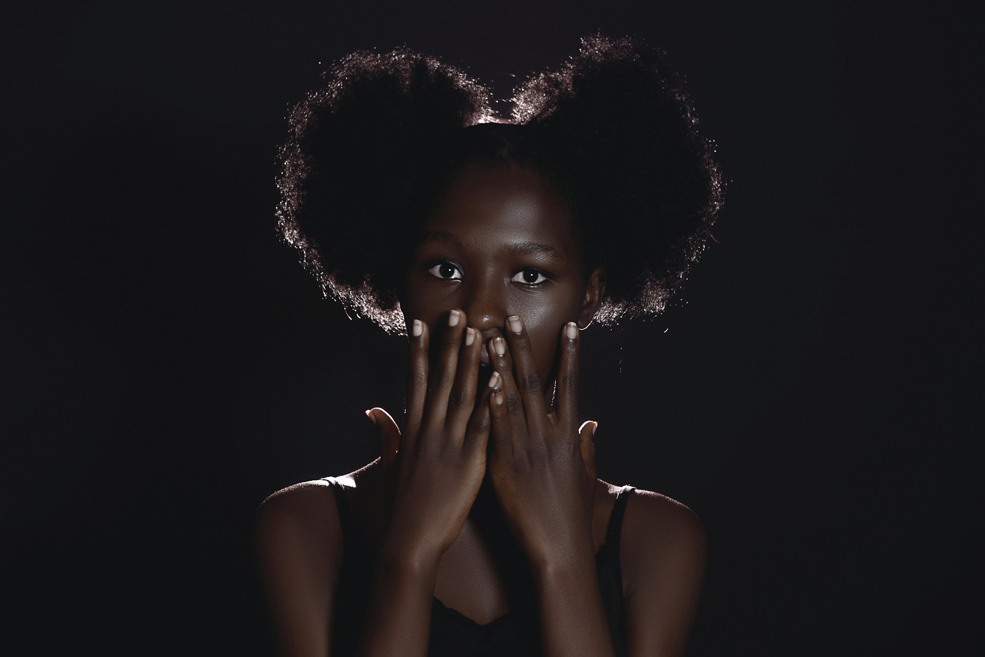 a woman covering her face with her hands