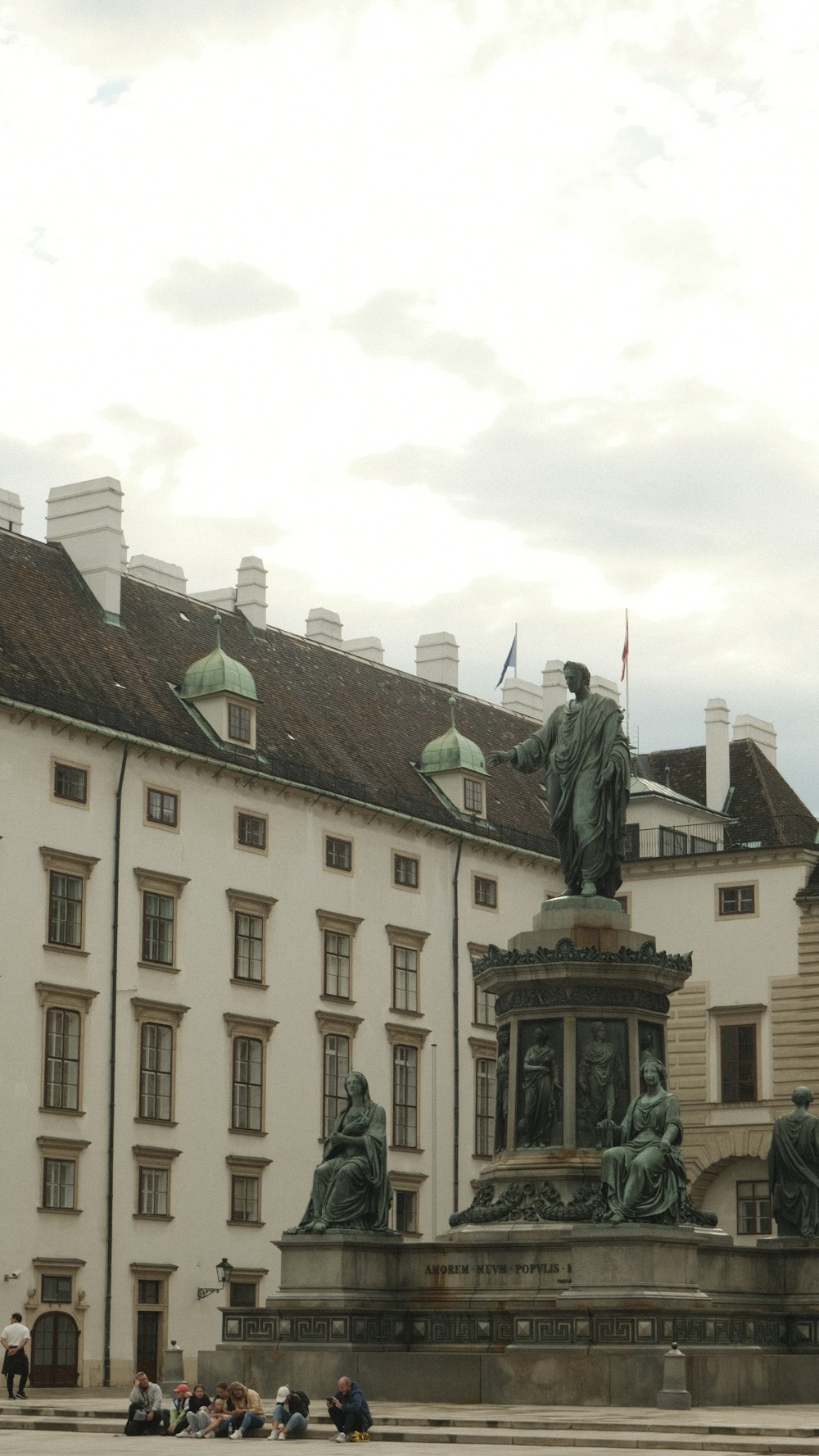 a statue in front of a building with many windows