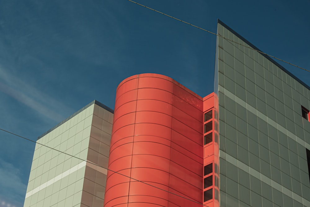 a tall building with a red and white tower