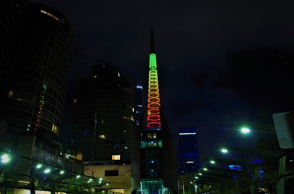 um edifício muito alto com uma luz muito colorida do seu lado