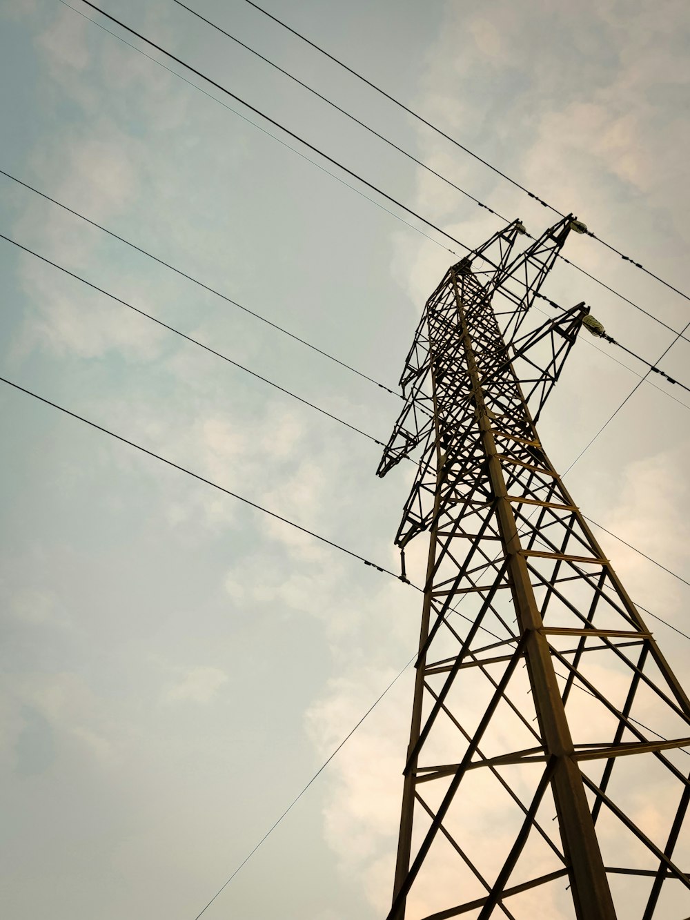 a tall metal tower sitting under a cloudy sky