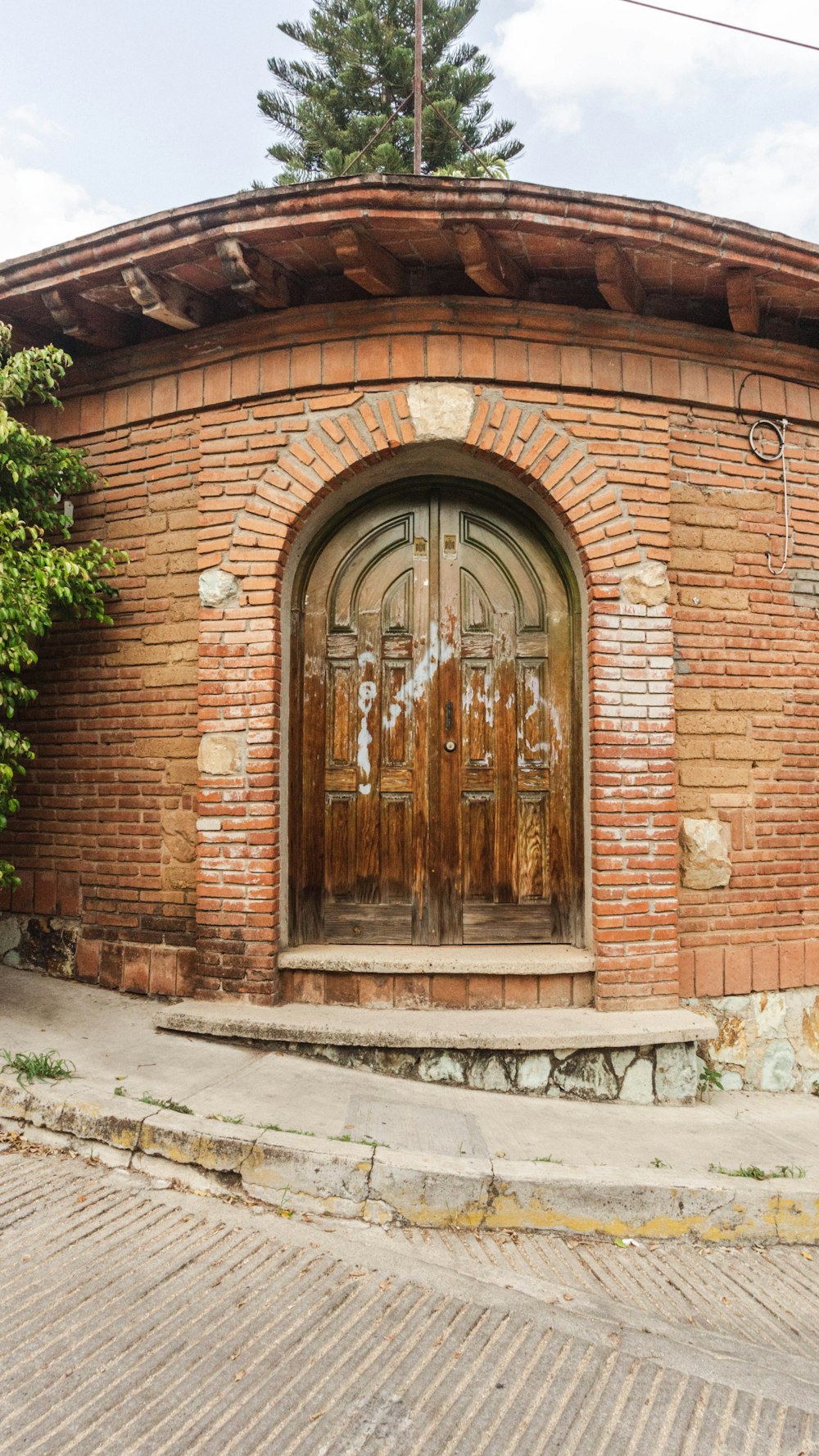 a brick building with a large wooden door