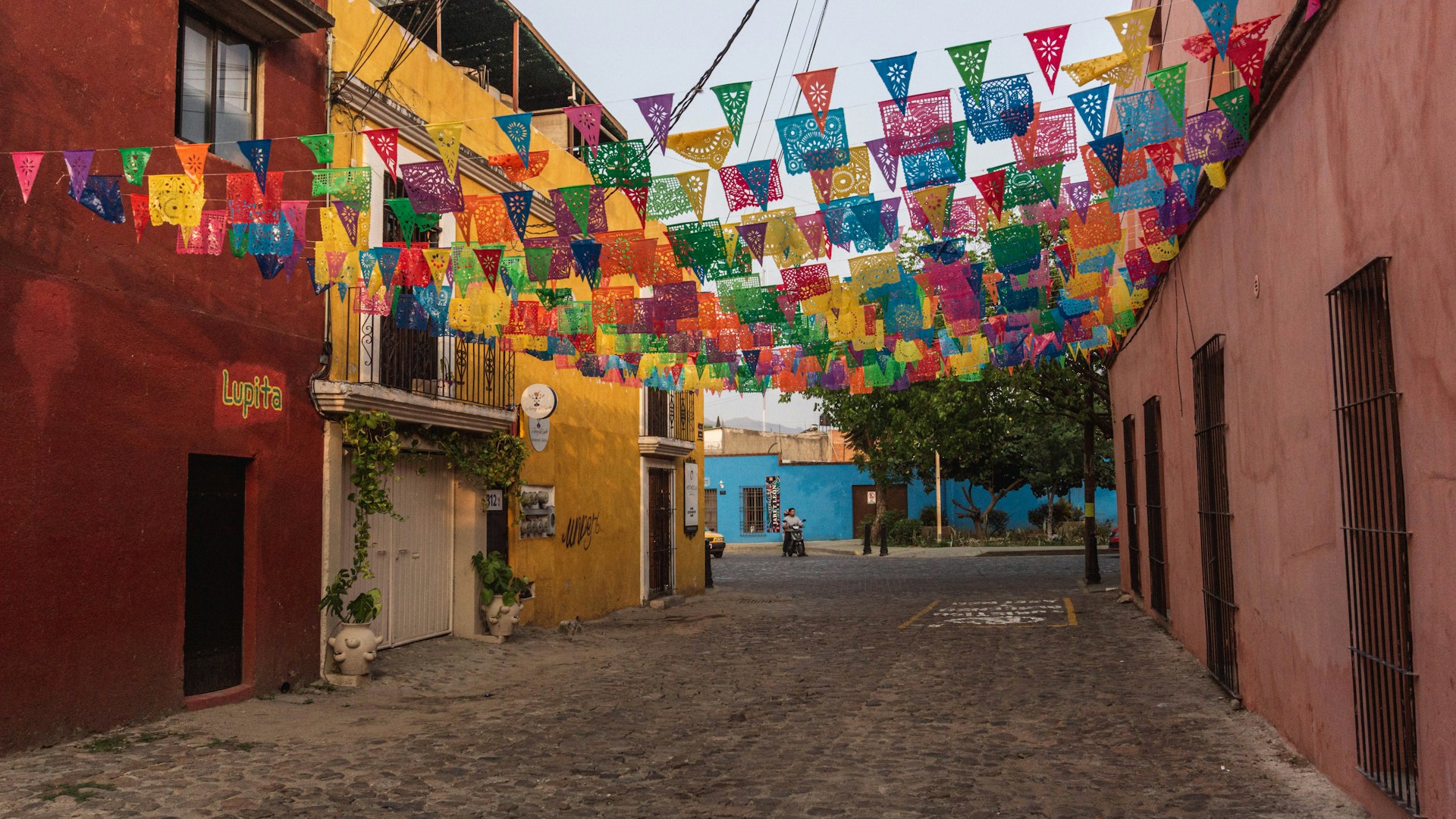 a street lined with colorful flags and buildings