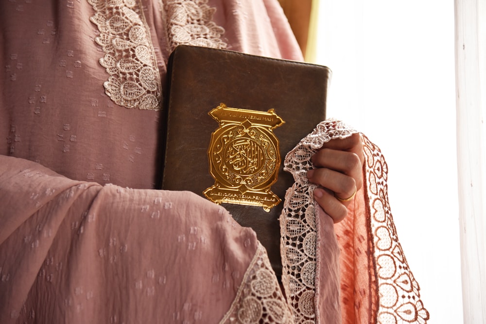 a close up of a person holding a book